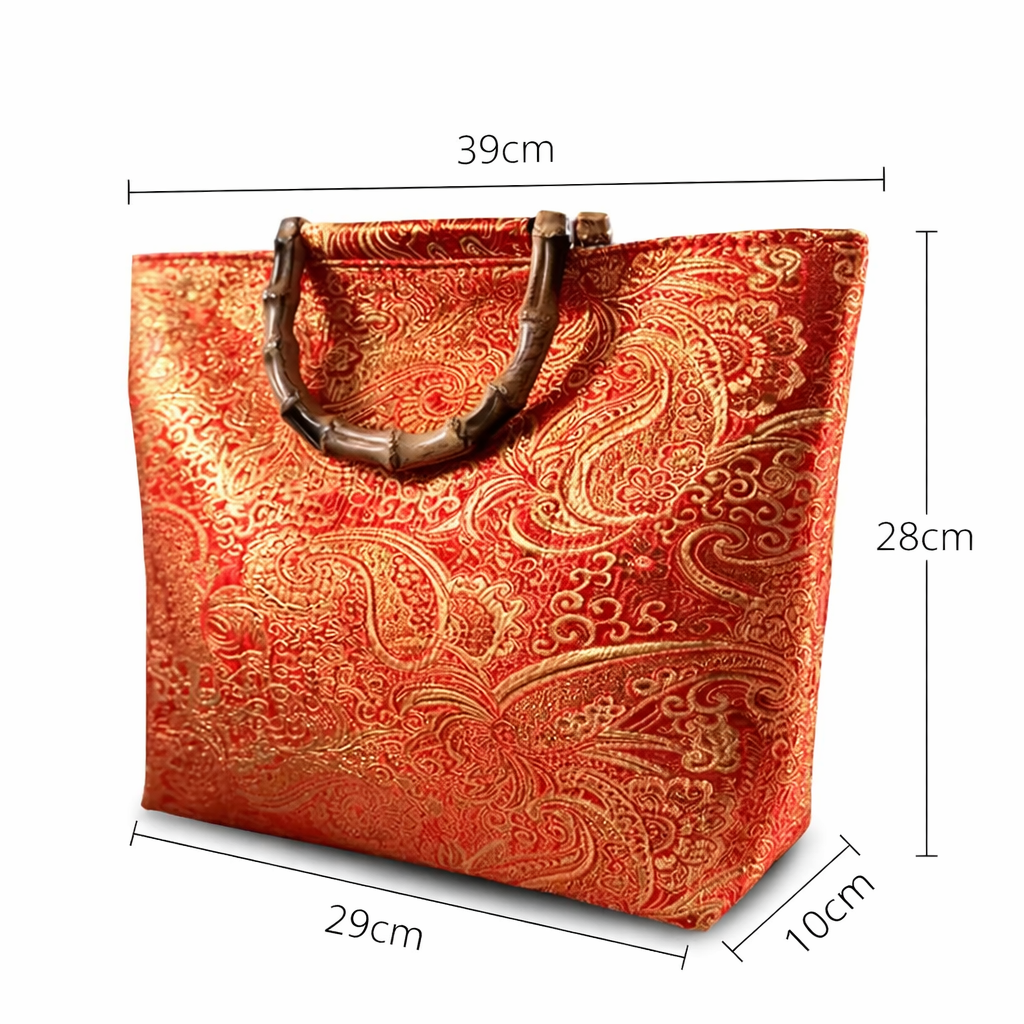Red and gold patterned handbag with dimensions on a white background