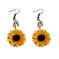 Sunflower earrings with leaf details on a white background