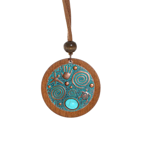 Necklace with a wooden pendant featuring circular patterns and a turquoise stone on a white background