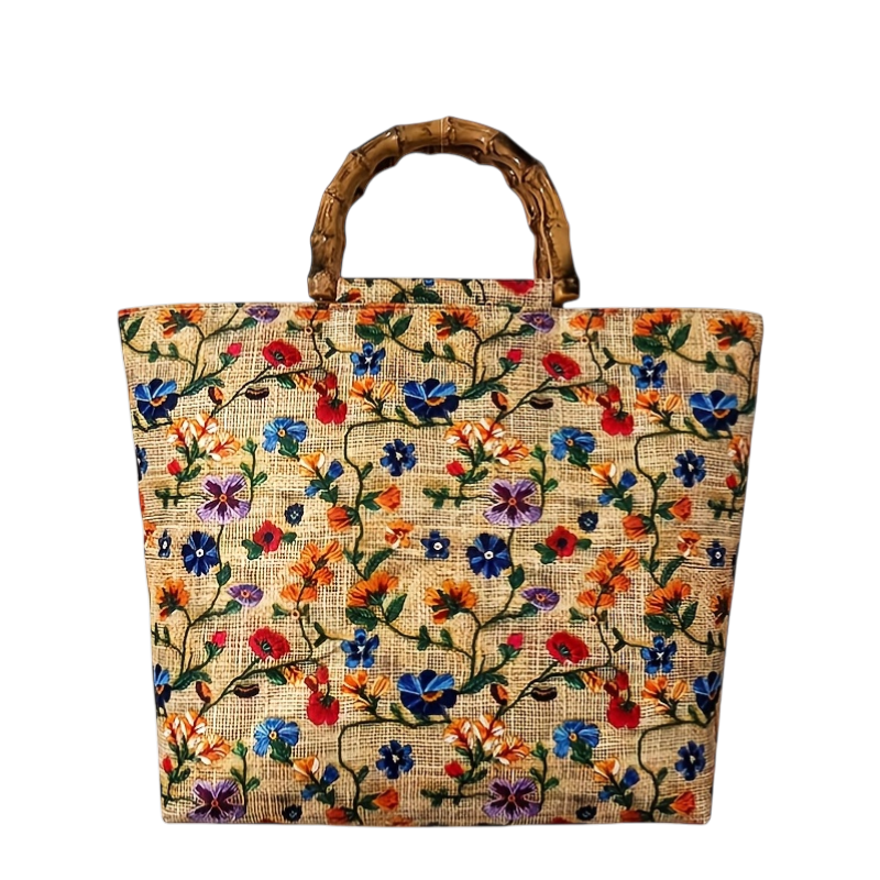Floral embroidered jute bag with wooden handle on a white background