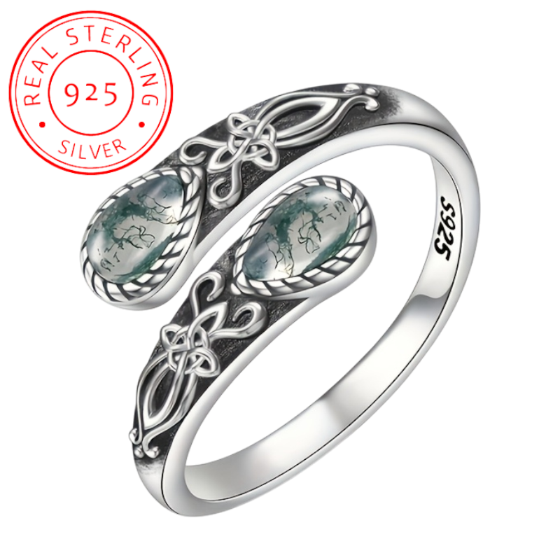 Silver ring with intricate designs and 'Real Sterling 925' stamp on a white background